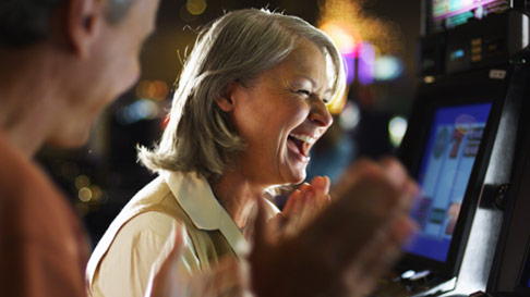 older couple excited at slot machines